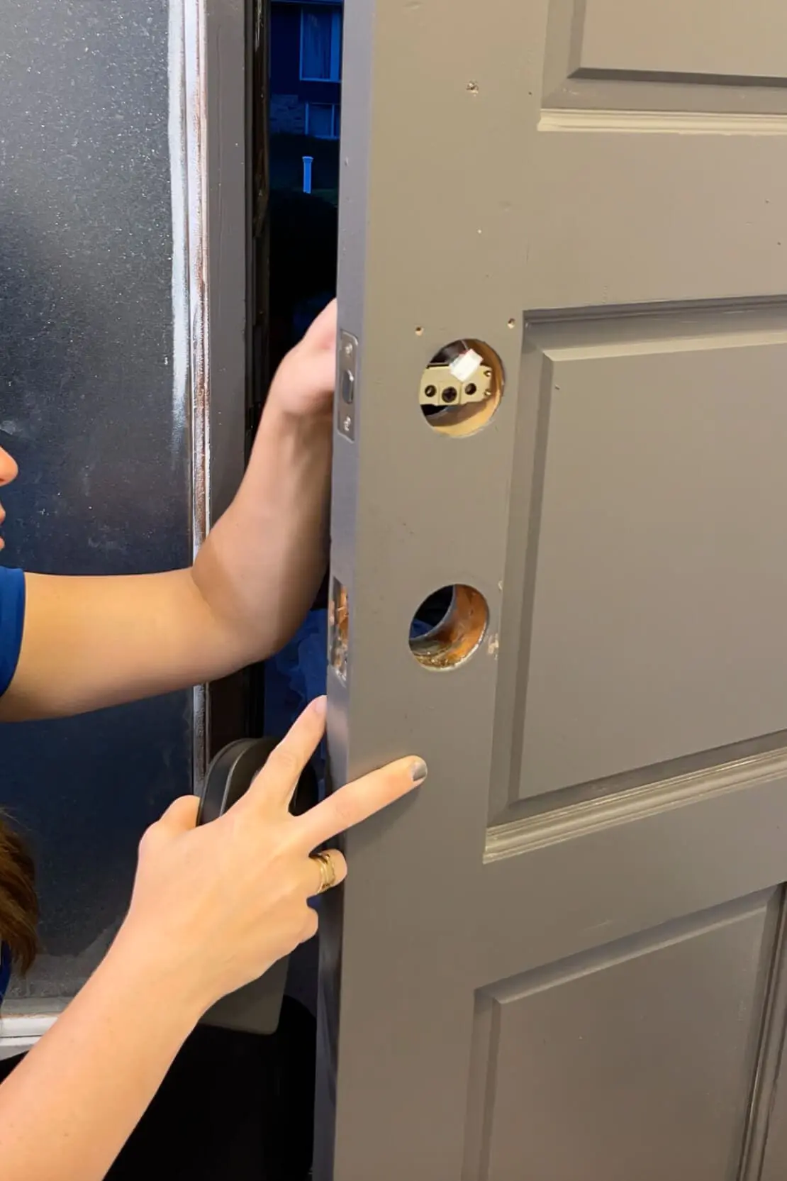 Installing a door handle on a freshly painted door.